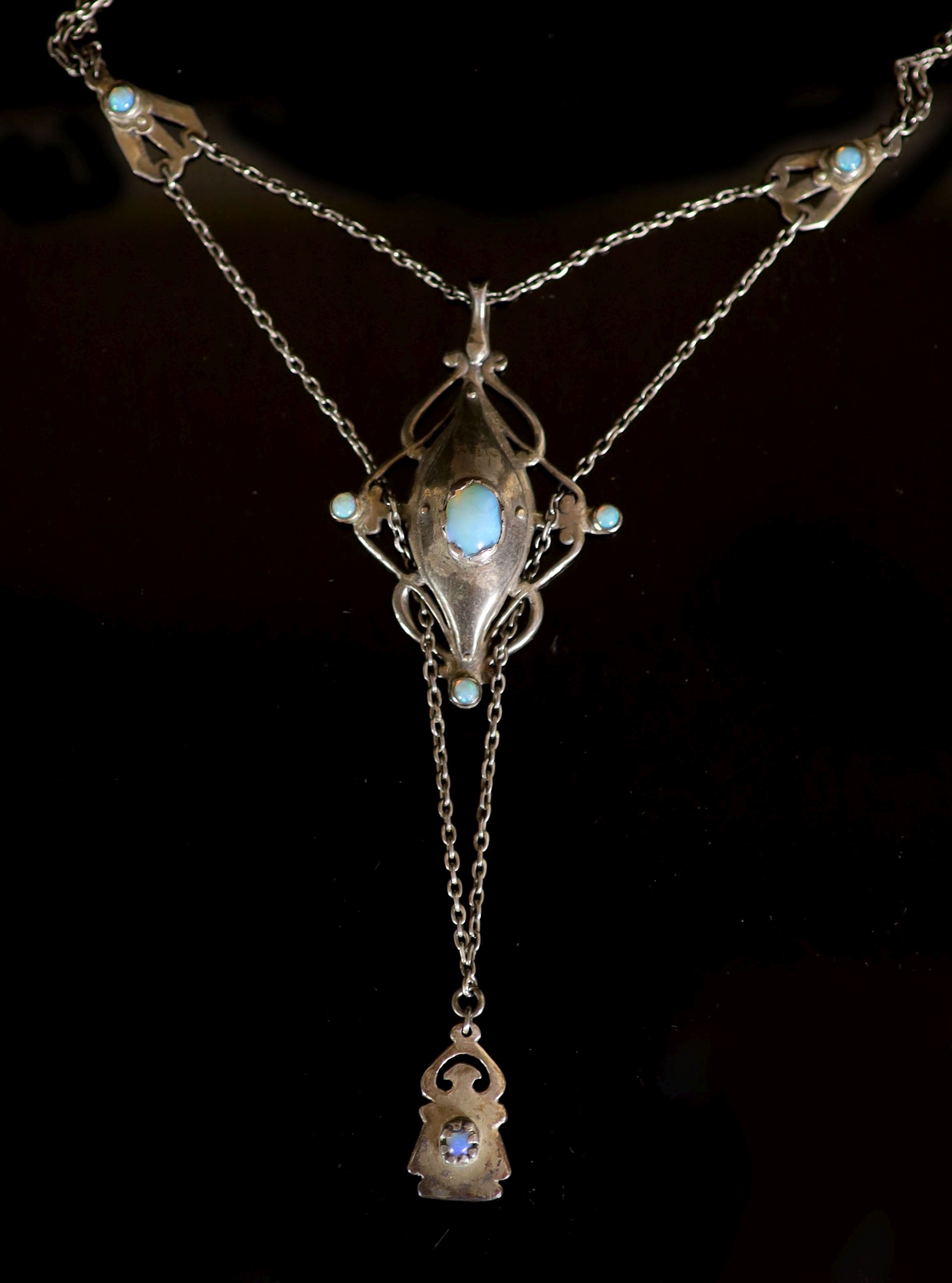 An early 20th century Arts & Crafts silver and nine stone cabochon black opal set drop pendant necklace